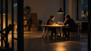Founder and developer planning an MVP at a single table in a sparse startup space